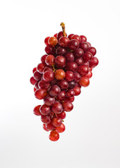 A bunch of red grapes on a white background