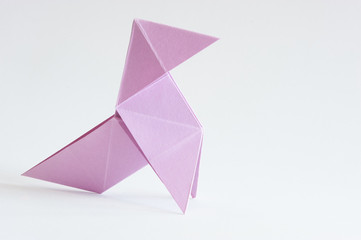 Photograph of a colored paper bow tie in front of a white background. Space for text. Background. For presentations