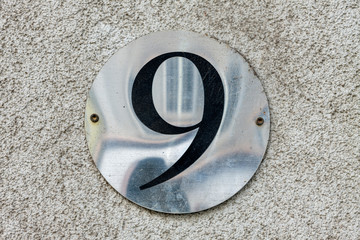 Street number sign on the wall