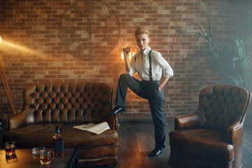 Woman in shirt and trousers with cigar in hand