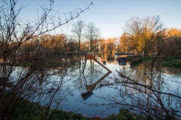 Whole playground with reflections in the Rhine flood.