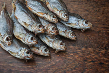some dried fish on a dark wooden background