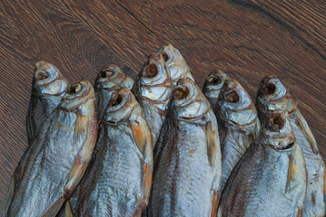 some dried fish on a dark wooden background