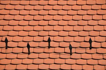 Fototapeta premium red tile roof texture with snow retainers