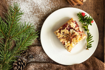 Apple pie bars with red berry jam, spices and crumble. Crumble cake. Christmas or New Year background.