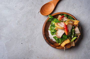 Stir-fried kale vegetable with rice and crispy pork ready to serve , food by order , thai street food (Ka-na-moo-krob)