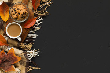 Fototapeta na wymiar Coffee with biscuit on background with scarf and fallen leaves