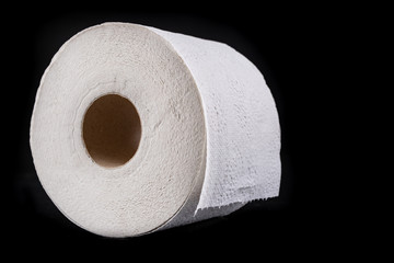 White soft toilet paper on a dark table. Personal hygiene accessories.