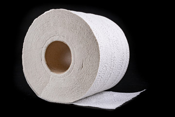 White soft toilet paper on a dark table. Personal hygiene accessories.