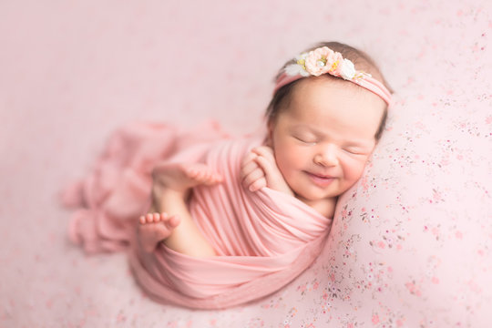 first photo shoot. newborn child. newborn.  the baby is lying on a pink blanket. newborn girl
