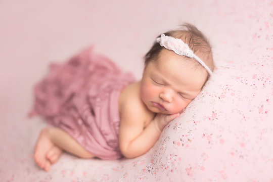 first photo shoot. newborn child. newborn.  the baby is lying on a pink blanket. newborn girl