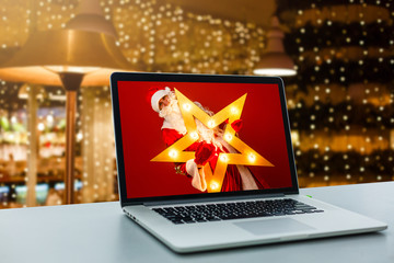 Brand new notebook with with display on table. Santa