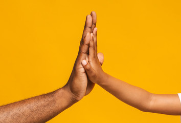 High five gesture of african father and child