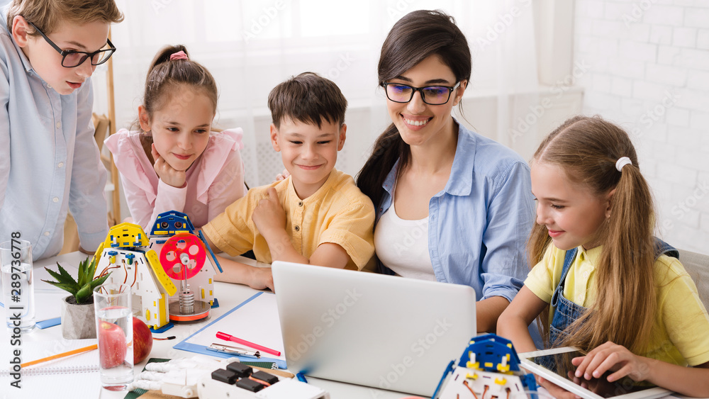 Poster Smart pupils with teacher enjoying science robotics lessons