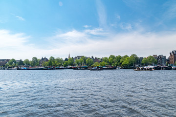 Oosterdok waterway with boats in Amsterdam, Netherlands.