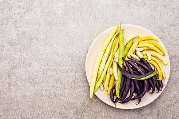 Assorted freshly colored beans in pods