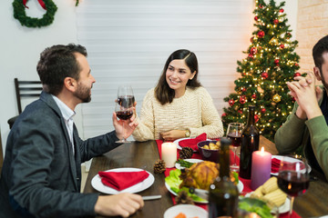 Happy Lovers Toasting Drinks At Home In Christmas