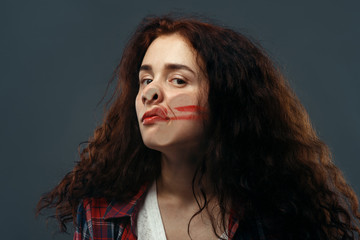 Fototapeta premium Woman's face crushed on glass, smeared lipstick