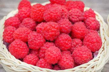 Red raspberries. Raspberries in basket on the table. Ripe red berry. Raspberry close-up on the table. Healthy and tasty food.