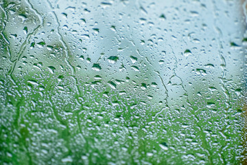 Natural water drop background.CAR Window glass with condensation of natural water drops .Abstract photo.