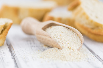 Some fresh Bread Crumbs on wooden background (selective focus; close-up shot)