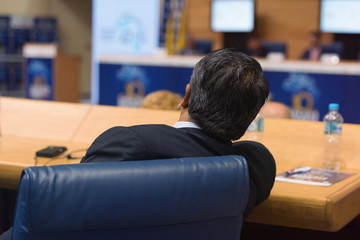 Businessman at business conference room with public giving presentations. Audience at the...