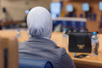 Muslim Business woman at business conference room with public giving presentations. Audience at the...