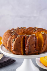 Pumpkin cake with honey on a gray background. Copy space.