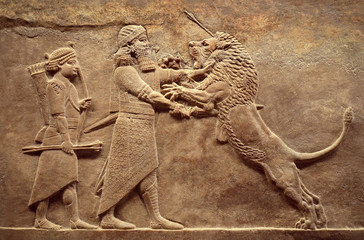 Assyrian relief of royal lion hunt, Babylonian and Sumerian art. Remains of ancient civilization of...