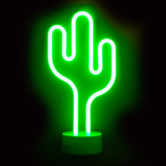 Neon green cactus LED lamp on black.