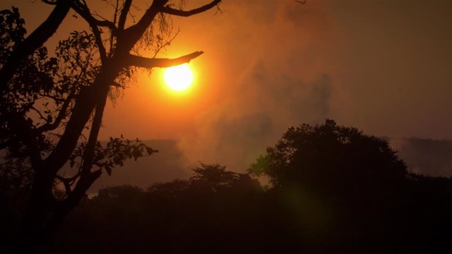 Sunrise in Africa with victoria waterfalls in the air Beautiful shot of victoria waterfalls in sunrise, Zimbabwe
