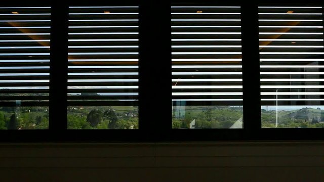 Rolling shutter of a window opening on the landscape. Countryside, hills.