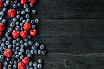 Various fresh summer berries. Mix of fruits and berries on black background. Fruit banner. Top view, overhead