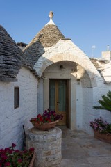 ALBEROBELLO, ITALY - AUGUST 27 2017: Entrance of a traditional trullo house in puglia region of Italy