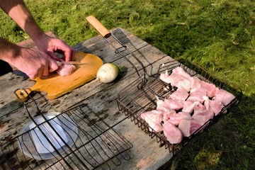laying pieces of raw meat on the grill, barbecue