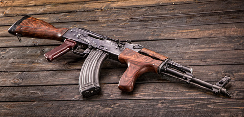 Romanian AK47 on wooden background.