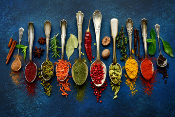 Assortment of natural spices on a vintage spoons.Top view with copy space.