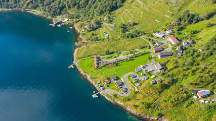 A small village in a green background between the fjords in Norway