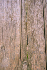 Fence from old weathered pine boards. Texture of natural aged wood. Woodworm holes, rusty nails. Creative vintage background.