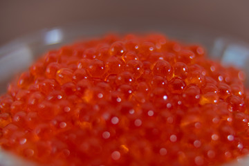 Red caviar in the glass jar close up macro