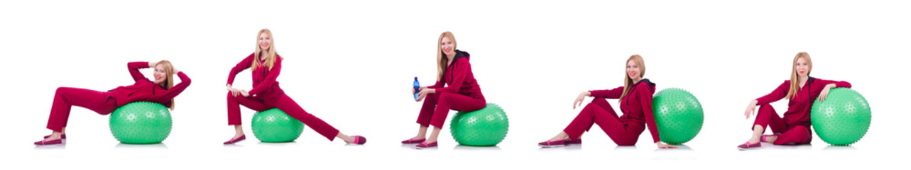 Young woman with ball exercising on white