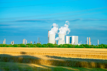Fototapeta na wymiar Power engineering and electric power generation concept. Cooling Tower and thermal power station. In thermal power station heat energy is converted to electric power.