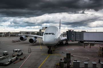 Airplane gate with a skybridge, at the airport with dark clouds