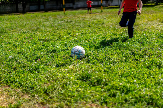 Boy runs to the ball playing football