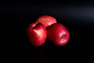 Fototapeta na wymiar Red apples on a black background