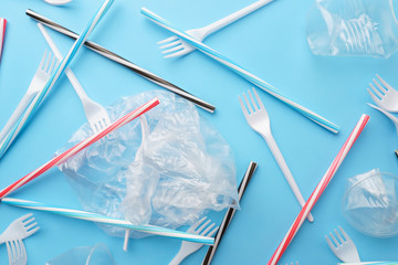 Plastic garbage on blue background. Ecological, environmental pollution, recycling and zero waste...
