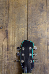 Close-up of a classic guitar mast with wooden background.