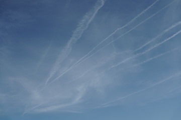 Blue sky with white trails