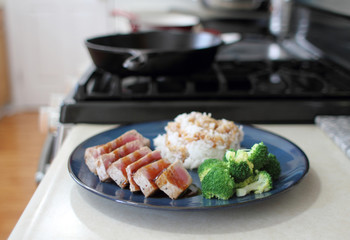 Ahi tuna sliced thin with teriyaki demi-glace, served with rice and broccoli.