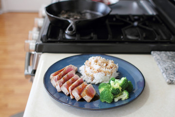 Ahi tuna sliced thin with teriyaki demi-glace, served with rice and broccoli.